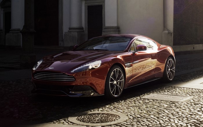 Aston Martin Vanquish in wine color on cobblestone street