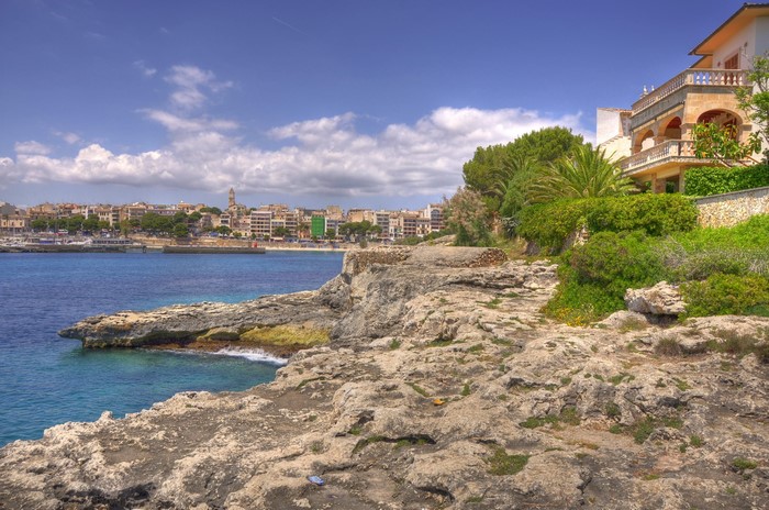 Rocky Coastline with Town and Buildings in Spain