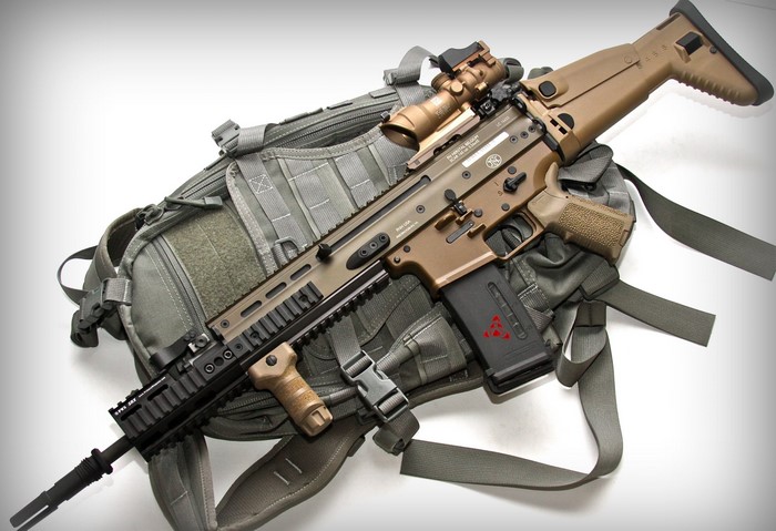 FN SCAR 16S assault rifle on a backpack