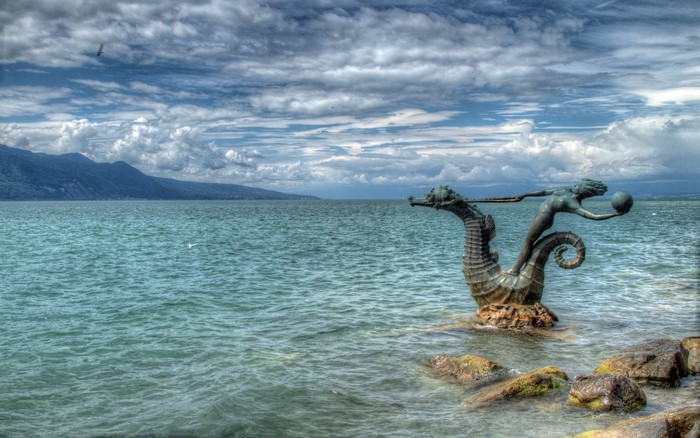 Statue of a mermaid riding a seahorse in Lake Geneva, Switzerland