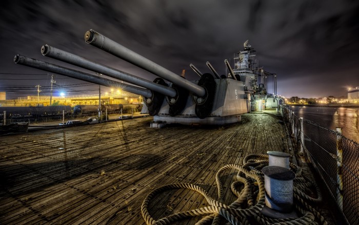 Battleship deck with large cannons at night