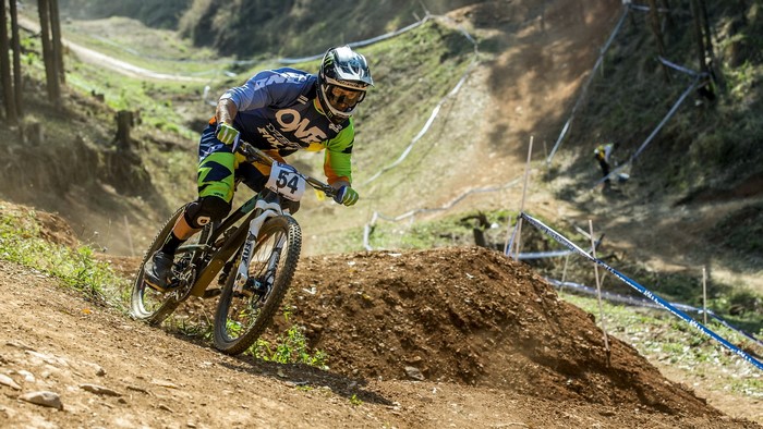 Mountain biker with number 54 on a dirt track