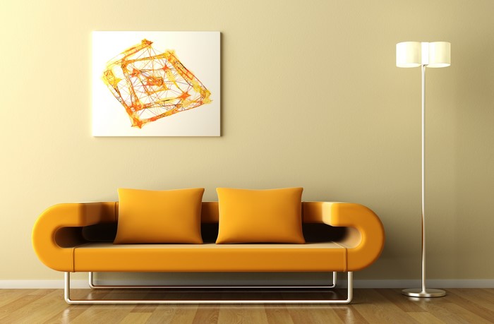 Sofa with yellow pillows and a floor lamp