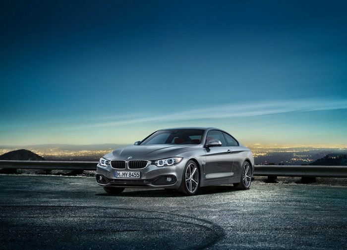 Grey BMW 4-Series Coupe on a Hillside Overlooking City Lights