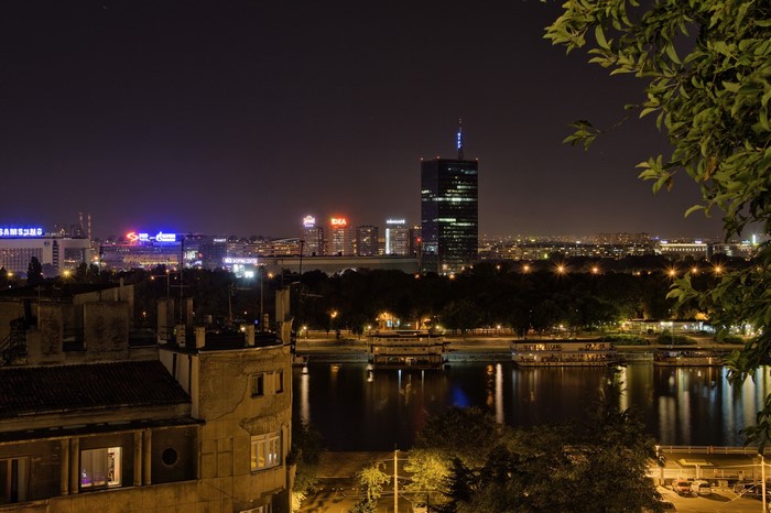 Belgrade skyline at night with river and buildings