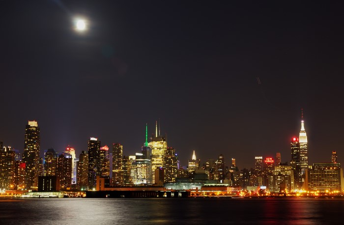 New York City skyline at night with moon