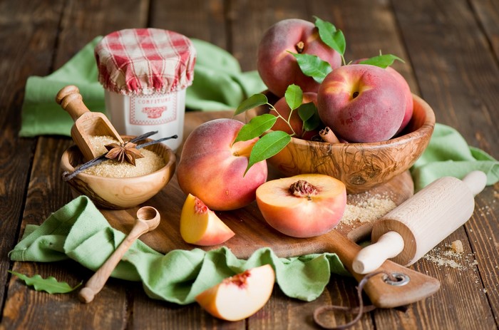 Peaches, Sugar, and Baking Ingredients on a Wooden Table