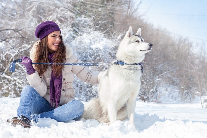 Woman and Husky Dog in Snow