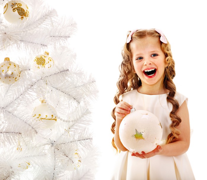 Little girl with Christmas ornaments