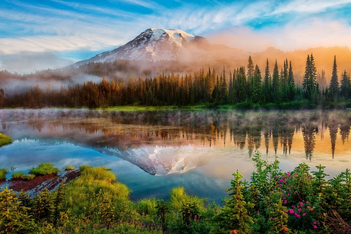 Mount Rainier reflected in a misty lake in Washington