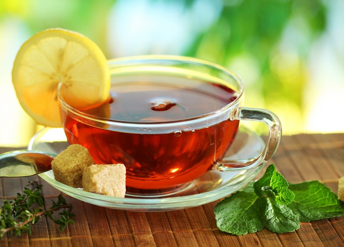 Tea with lemon, sugar cubes, and mint