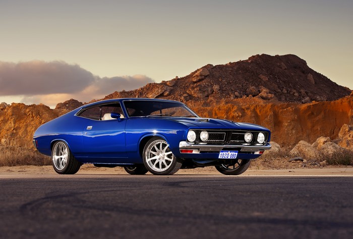 Blue Ford Falcon GT parked on a road