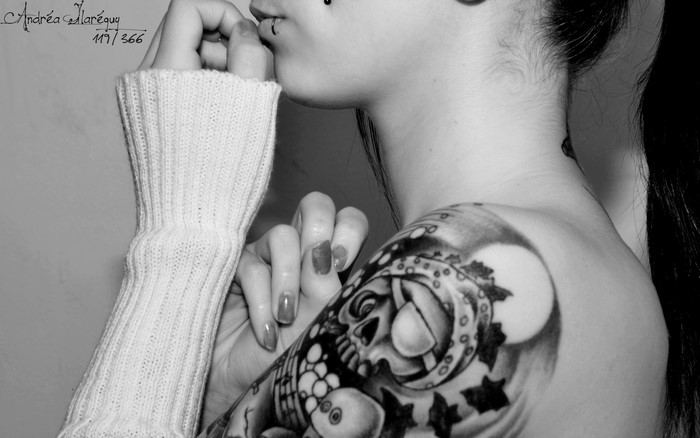 Woman with skull tattoo and sweater