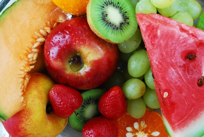 Assortment of fresh fruits including apple, kiwi, watermelon, grapes, strawberries, and melon