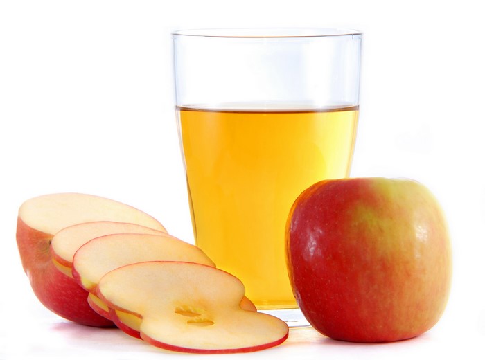 Apple juice in a glass with apples