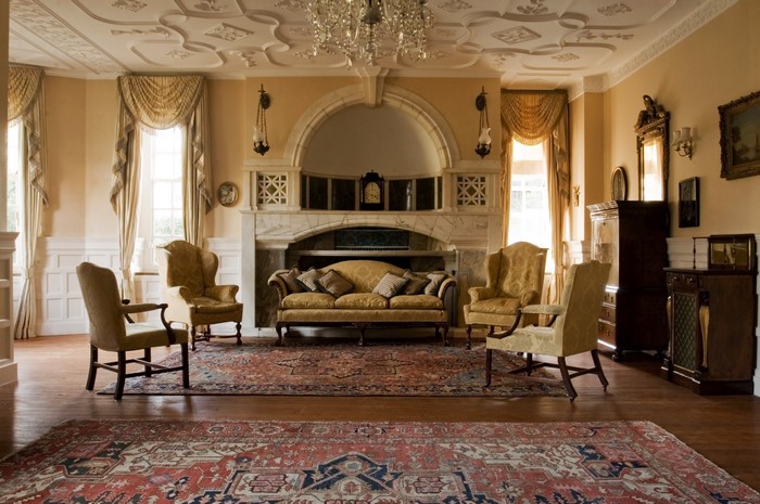 Elegant living room with ornate fireplace and antique furniture