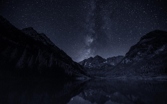 Night sky over mountains and lake