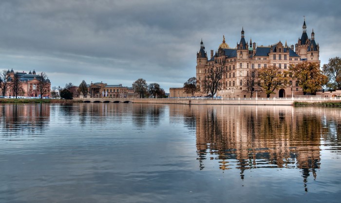 Schwerin Castle reflected in the water under a cloudy sky