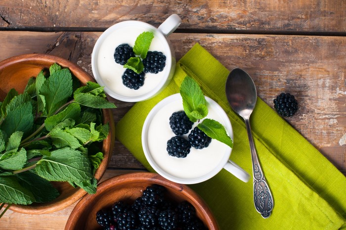 Dessert cups with blackberries and mint leaves