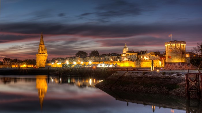La Rochelle harbor towers at dusk