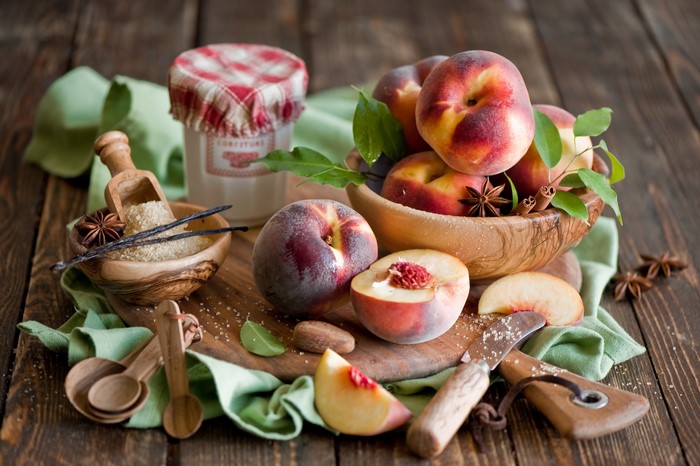 Peaches and ingredients for jam on a wooden table