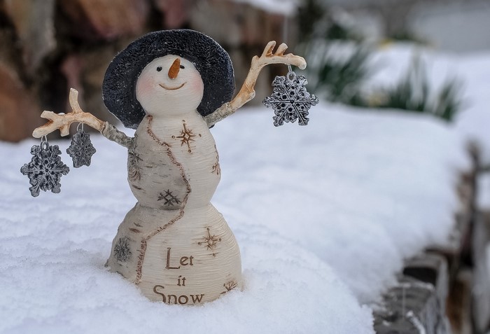 Snowman decoration with snowflakes in the snow