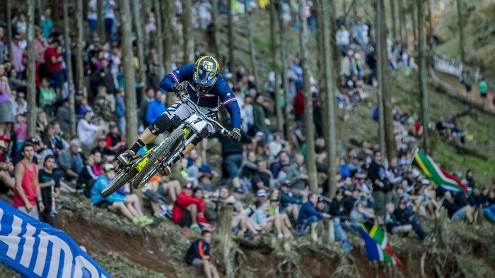 Mountain biker jumps over a crowd at a race