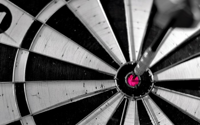 Dart hitting the bullseye on a dartboard
