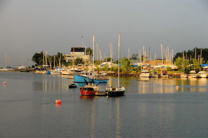 Boats docked in a harbor with a building in the background