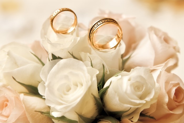 Wedding Rings on White Roses Bouquet