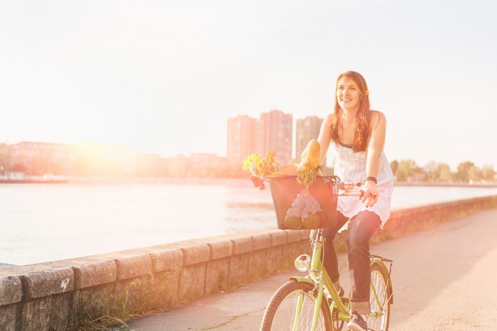 Woman riding a bicycle with groceries