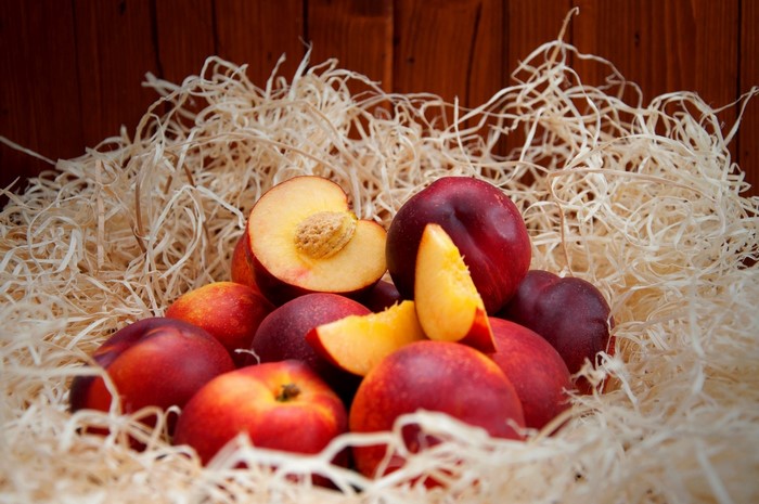 Nectarines and peach slices in straw