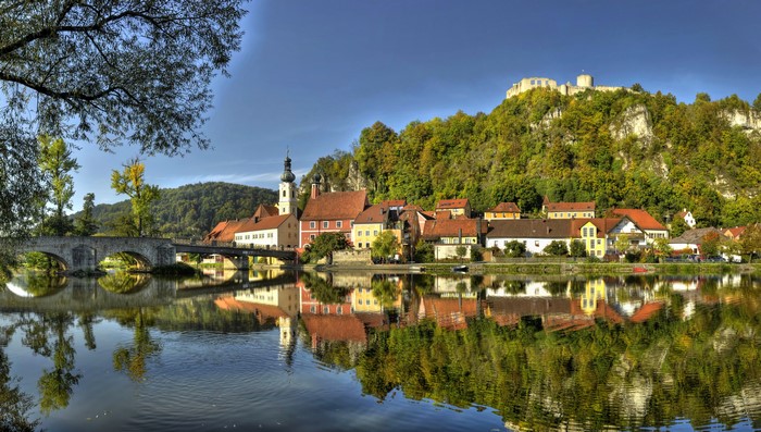 Town with Castle on Hill over River in Bavaria, Germany