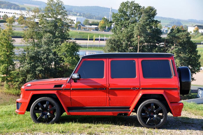Red Mercedes-Benz G63 AMG parked on grass