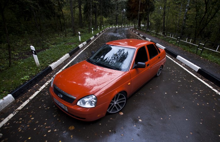 Orange Lada on a Wet Road in a Forest