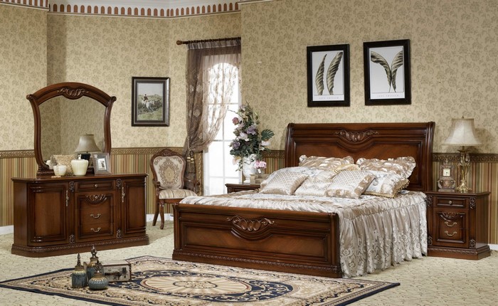 Bedroom with ornate wooden furniture and floral wallpaper