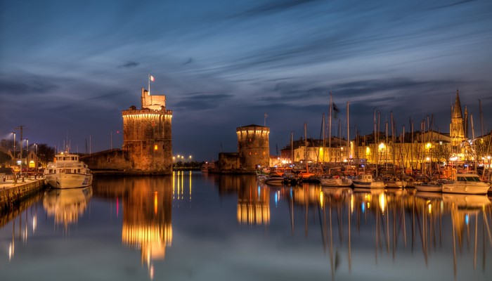 La Rochelle harbor towers and marina at night
