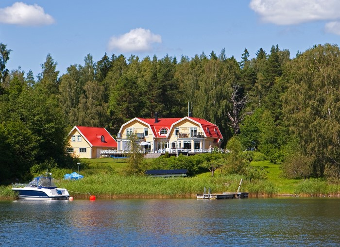 Yellow houses with red roofs by a lake in Sweden