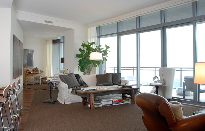 Living room with sofa, armchair, and large windows