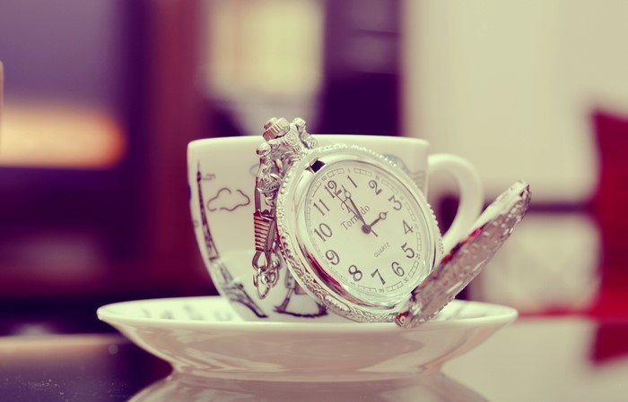 Pocket watch on a cup with Eiffel Tower design