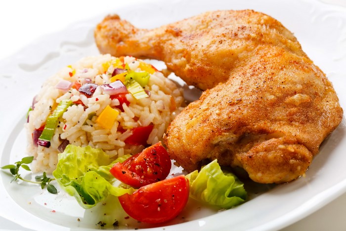 Roasted chicken leg with rice and salad