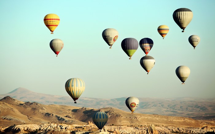 Hot air balloons over a desert landscape