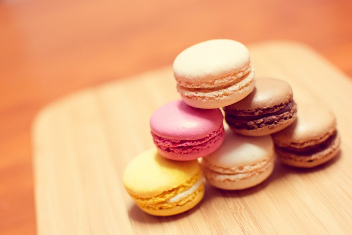 Stack of colorful macarons on a wooden board