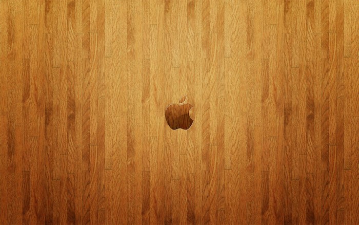 Apple logo carved into a wooden surface