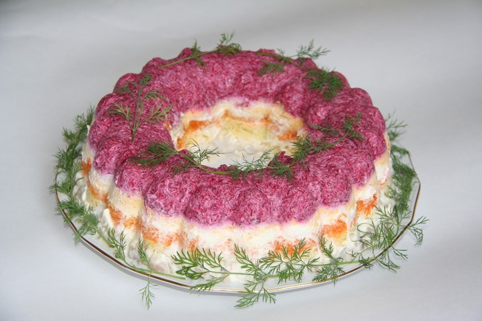 Layered salad with beets and dill on a plate