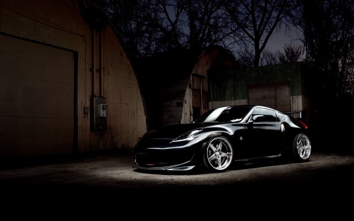 Black Nissan 370Z parked outside a warehouse