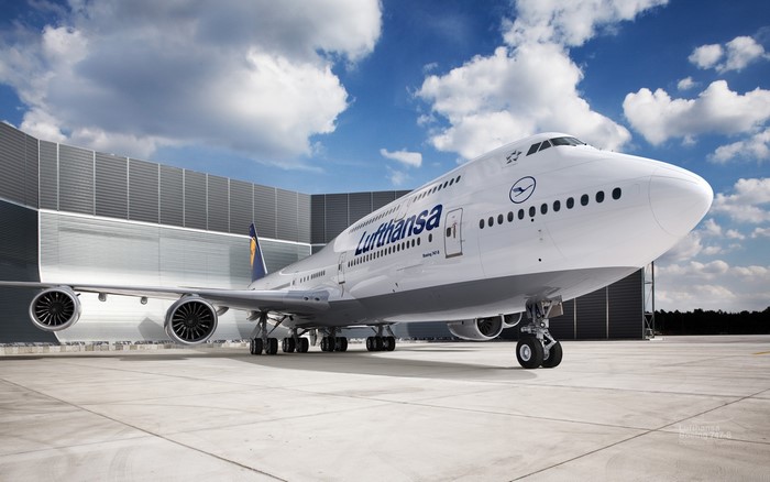 Lufthansa Boeing 747-8 airplane parked outside hangar