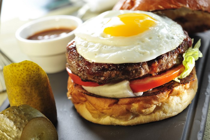Hamburger with fried egg and pickles