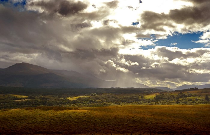 Dramatic clouds over Scottish landscape with mountains