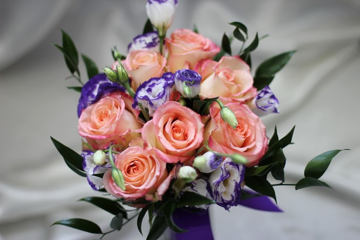 Peach and purple rose bouquet with greenery